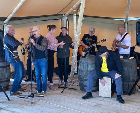 A live band playing under the tipi