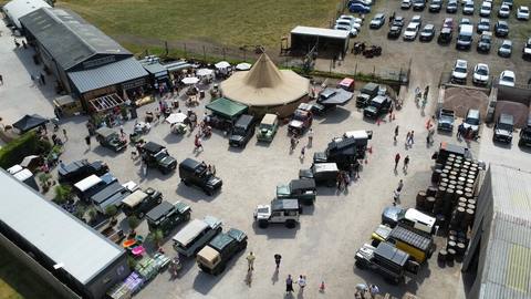The gathering outside the farm shop and tipi