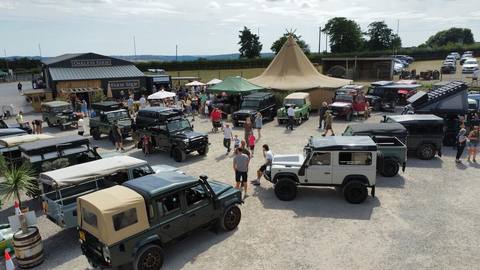 Defenders parked up beside the tipi